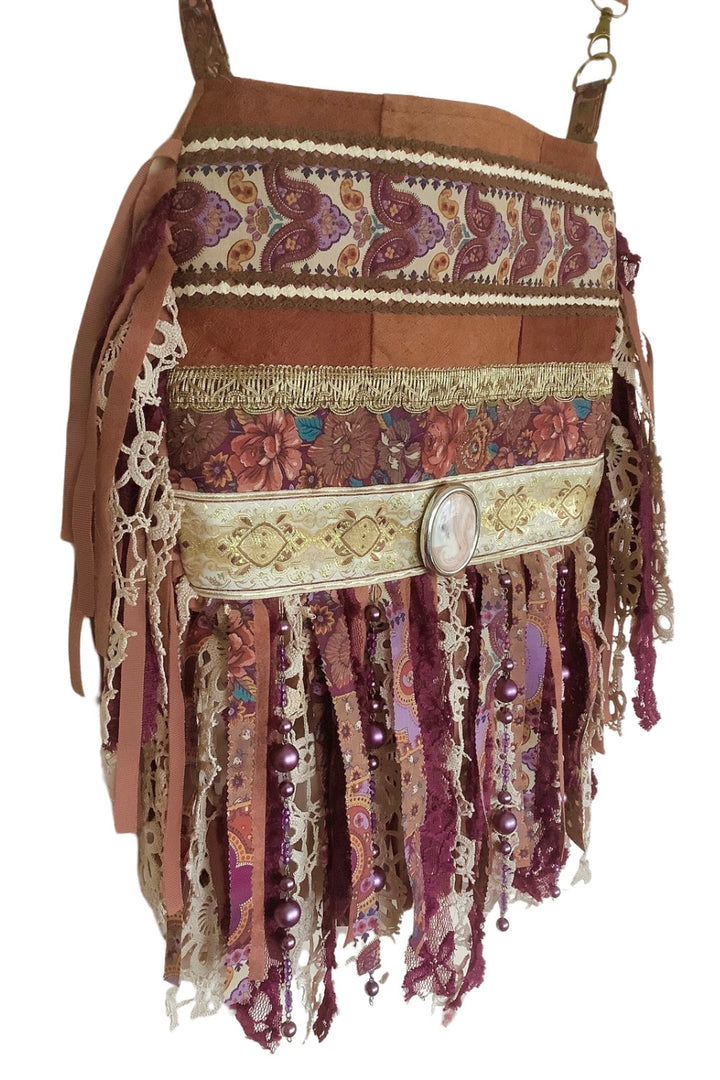 Barkcloth crossbody bag with fringes and ribbons from the left side