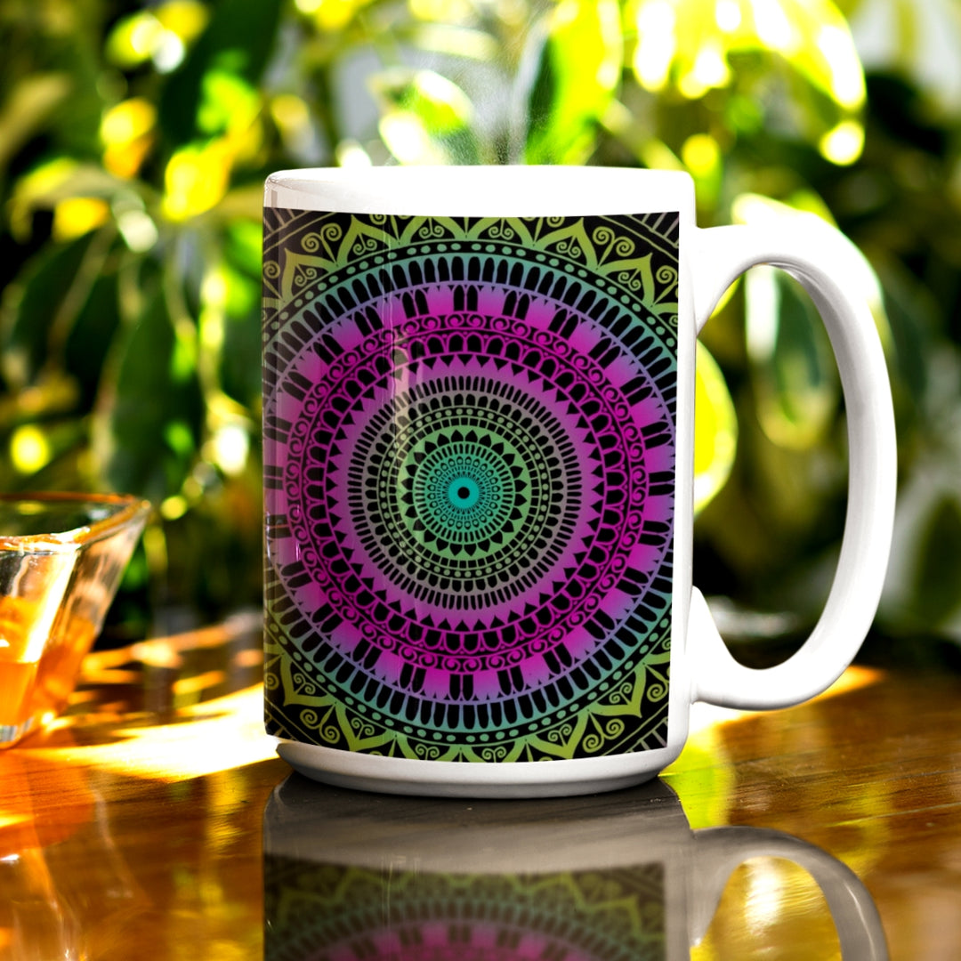 A mandala mug in pink and green with a subtle mehndi design