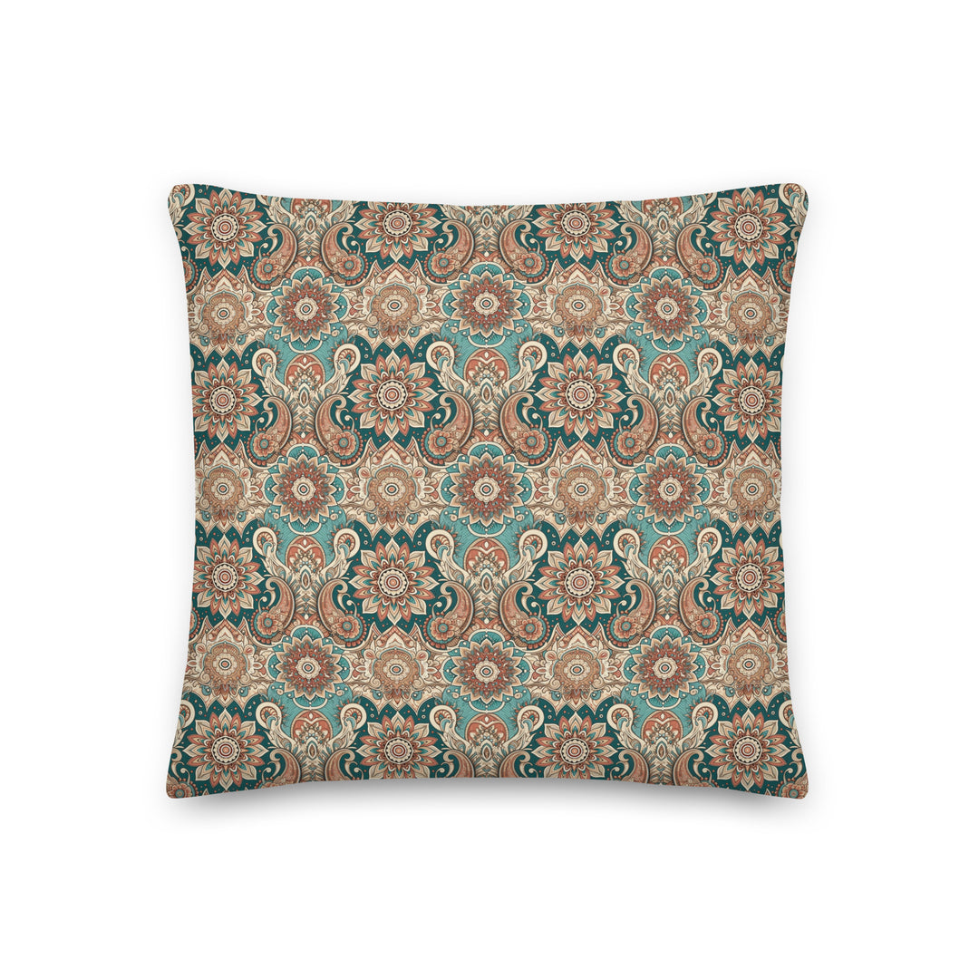 A decorative pillow with an intricate paisley and mandala pattern in muted turquoise, brown, and cream hues, set against a light background.