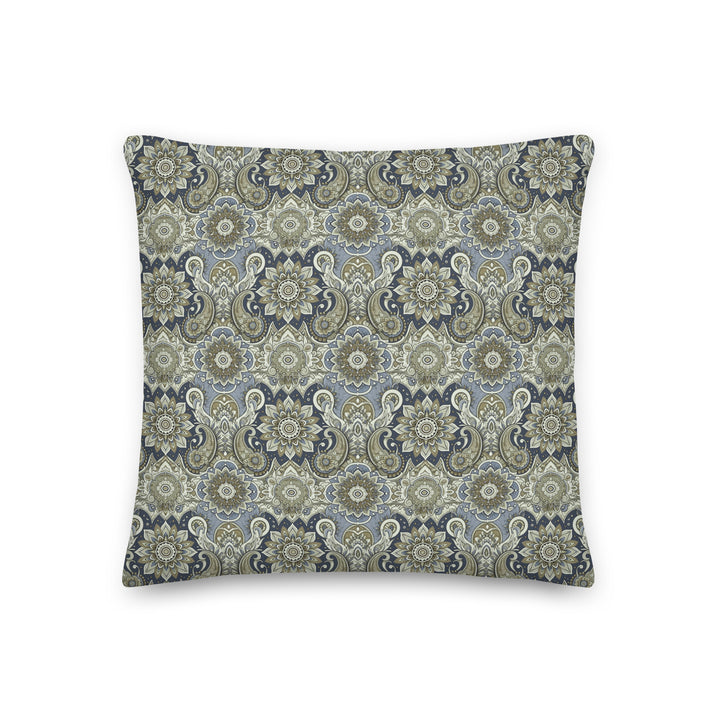 "A decorative lumbar pillow with an intricate paisley and mandala pattern in muted blue, gray, and beige hues