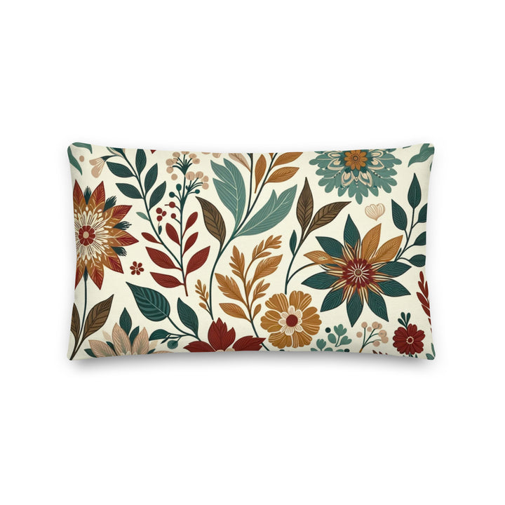 A decorative pillow with a beautiful floral pattern featuring various flowers and leaves in warm, autumnal colors