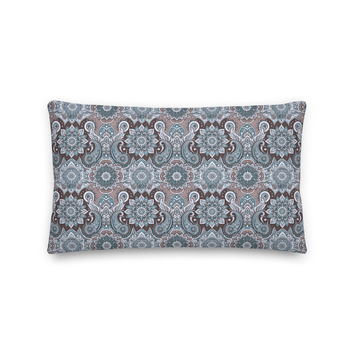 A decorative pillow with an intricate paisley and mandala pattern in soothing blue, gray, and taupe hues