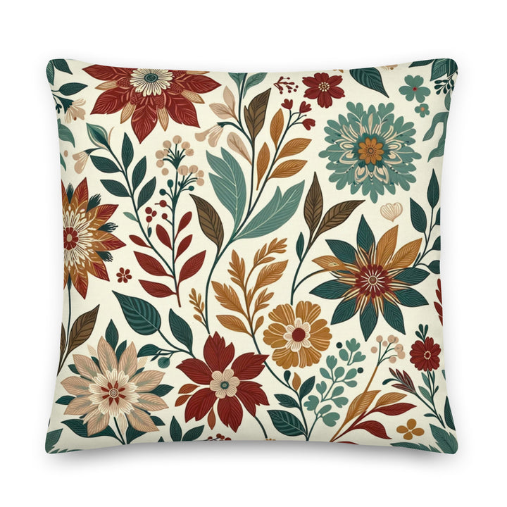 A decorative pillow with a beautiful floral pattern featuring various flowers and leaves in warm, autumnal colors