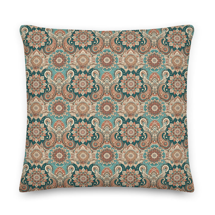 A decorative pillow with an intricate paisley and mandala pattern in muted turquoise, brown, and cream hues, set against a light background.