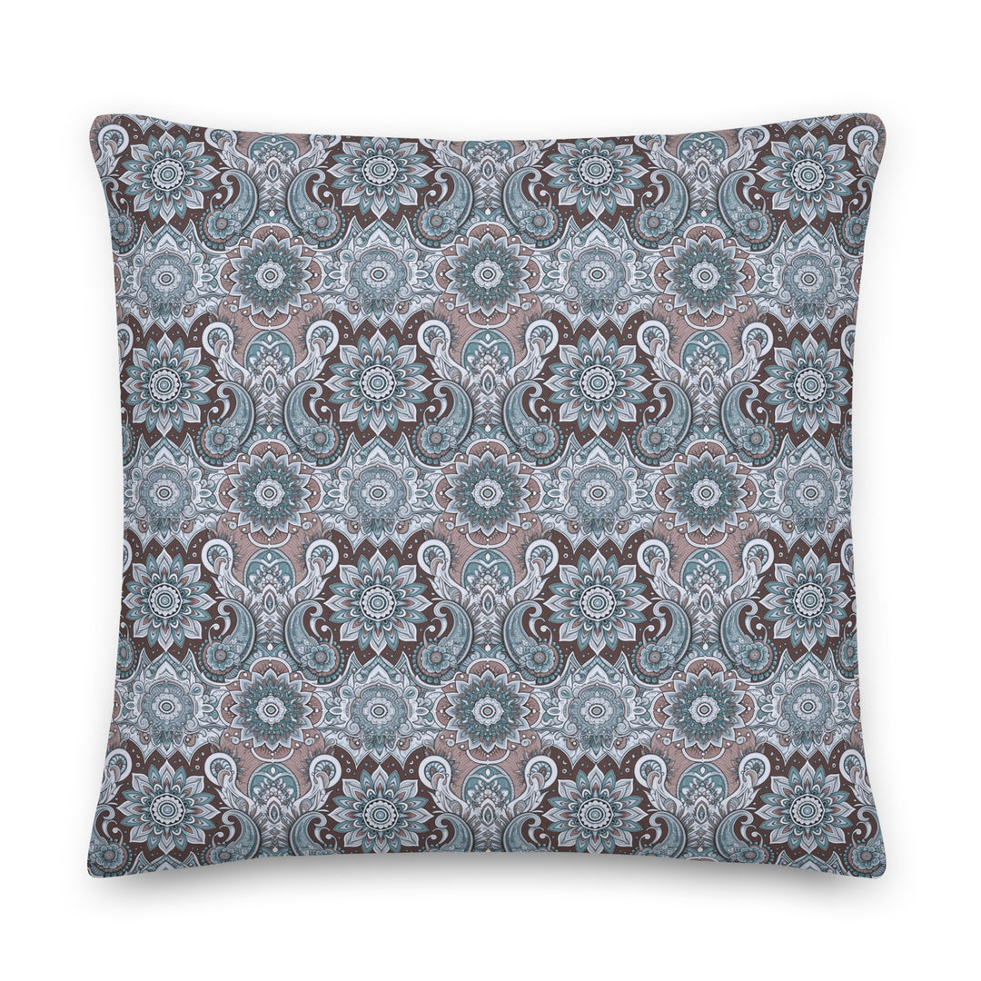 A decorative pillow with an intricate paisley and mandala pattern in soothing blue, gray, and taupe hues