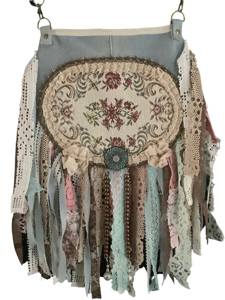 crossbody bag made of light denim with lace fringes