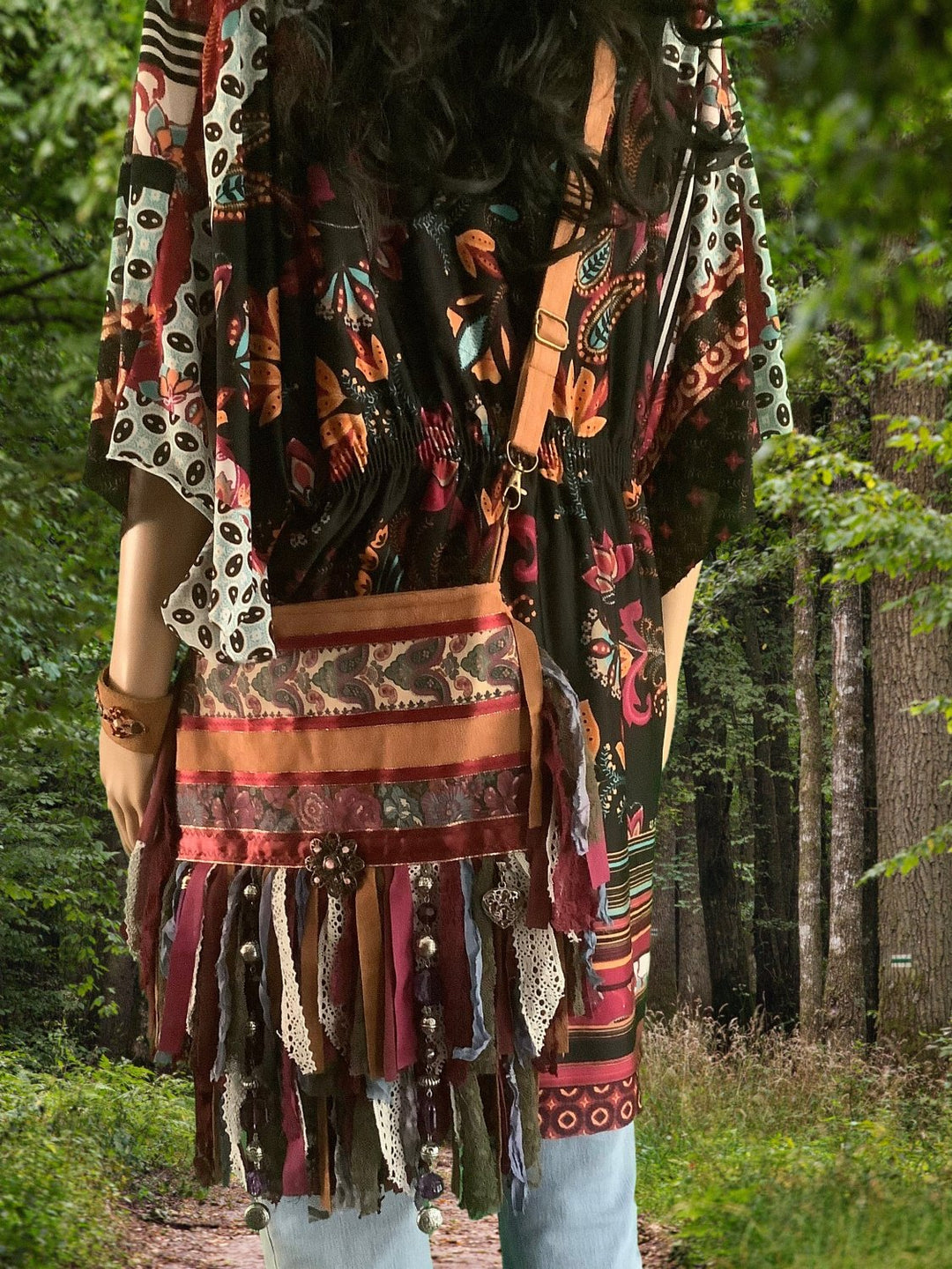 woman in woods carrying a crossbody bag in faux suede