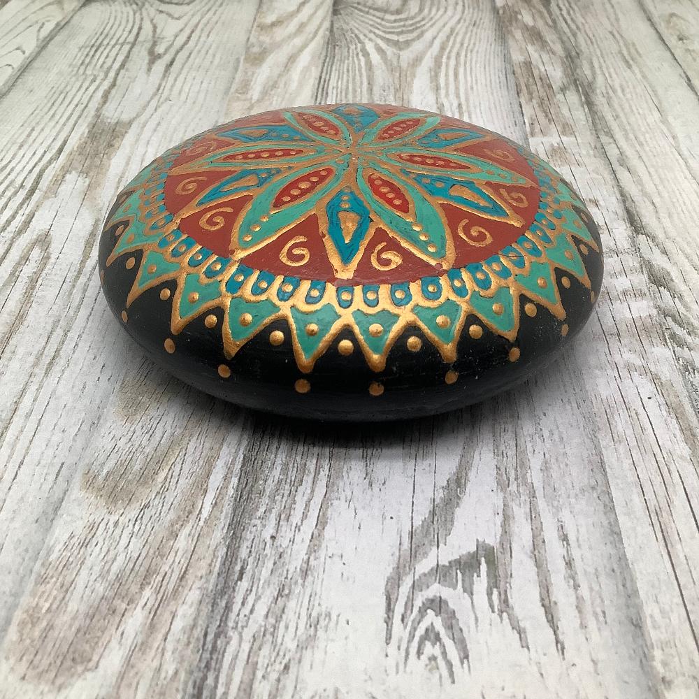 Southern-style mandala stone with intricate patterns in turquoise, red, and gold, ideal for home decor or meditation.