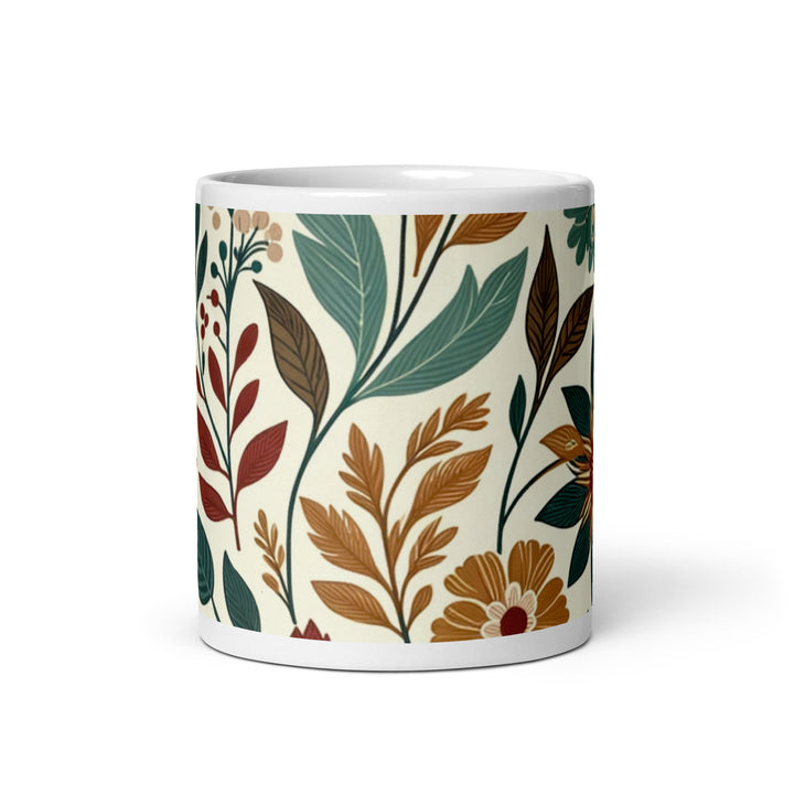 White ceramic mug with a vintage-inspired floral pattern featuring green, brown, and orange flowers and leaves.