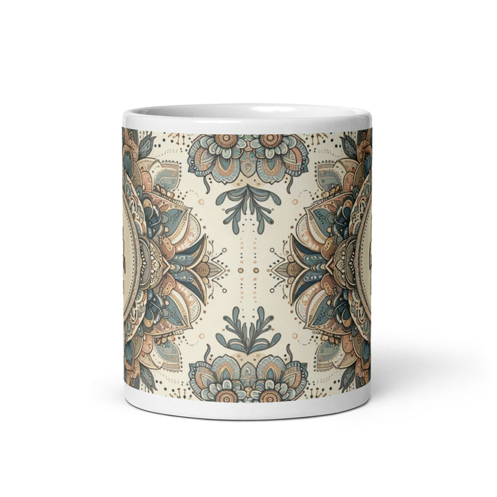 White ceramic mug with a detailed blue and beige mandala design and the phrase 'Live Laugh Love' in the center.