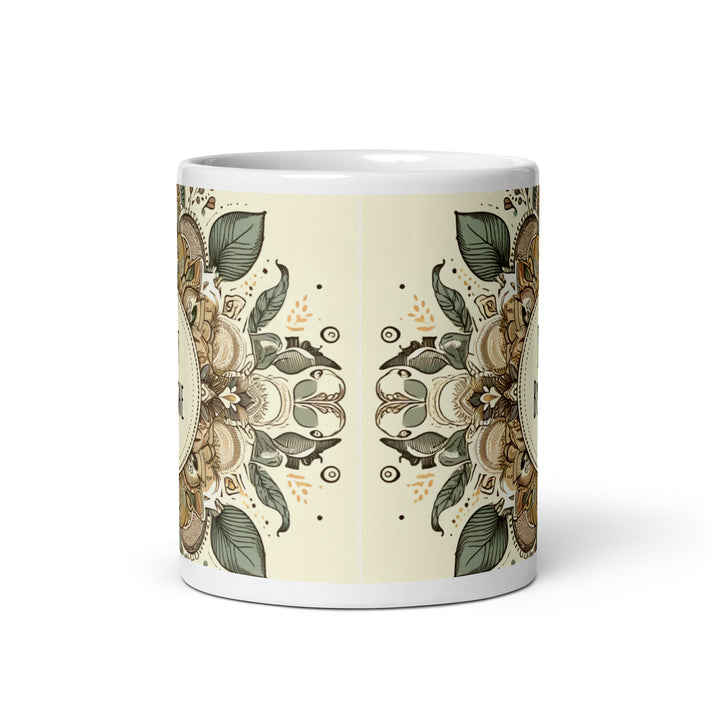 A white glossy mug with an intricate mandala design in earthy tones and the text 'Just Breathe' in the center.