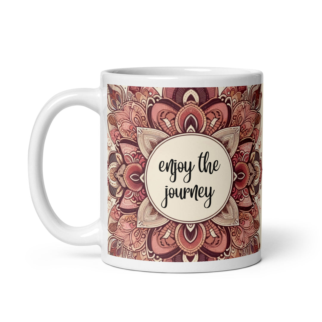 White ceramic mug with a detailed pink and brown mandala design and the phrase 'Enjoy the Journey' in the center