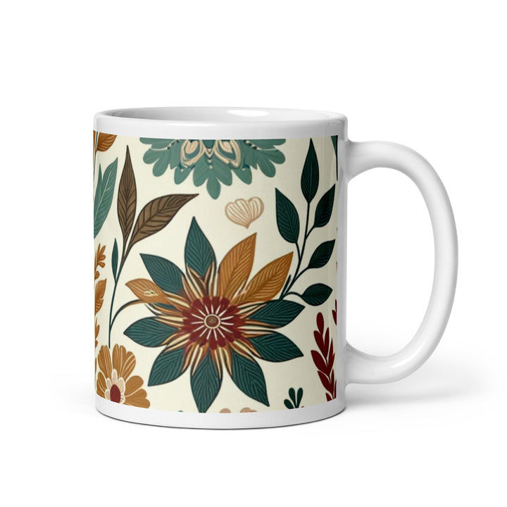 White ceramic mug with a vintage-inspired floral pattern featuring green, brown, and orange flowers and leaves.