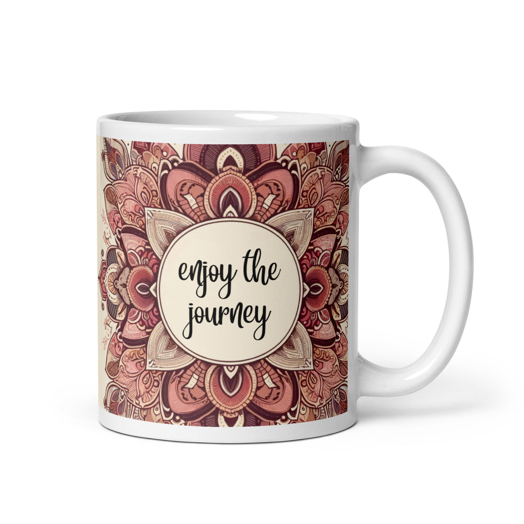 White ceramic mug with a detailed pink and brown mandala design and the phrase 'Enjoy the Journey' in the center