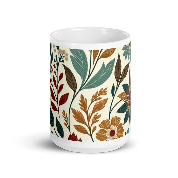 White ceramic mug with a vintage-inspired floral pattern featuring green, brown, and orange flowers and leaves.