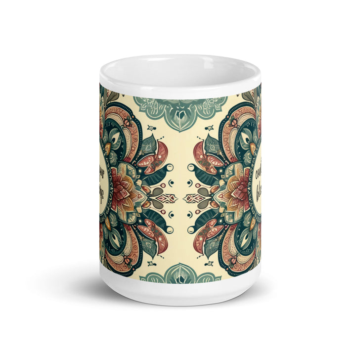 White ceramic mug with a detailed green, red, and gold mandala design and the phrase 'Count Your Blessings' in the center.