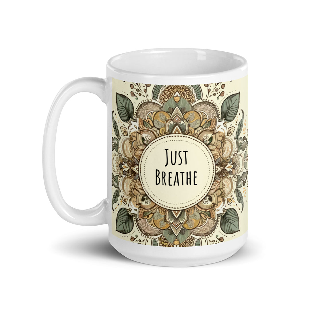 A white glossy mug with an intricate mandala design in earthy tones and the text 'Just Breathe' in the center.