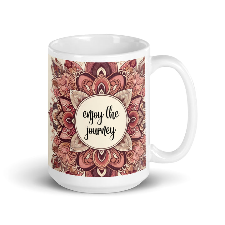 White ceramic mug with a detailed pink and brown mandala design and the phrase 'Enjoy the Journey' in the center